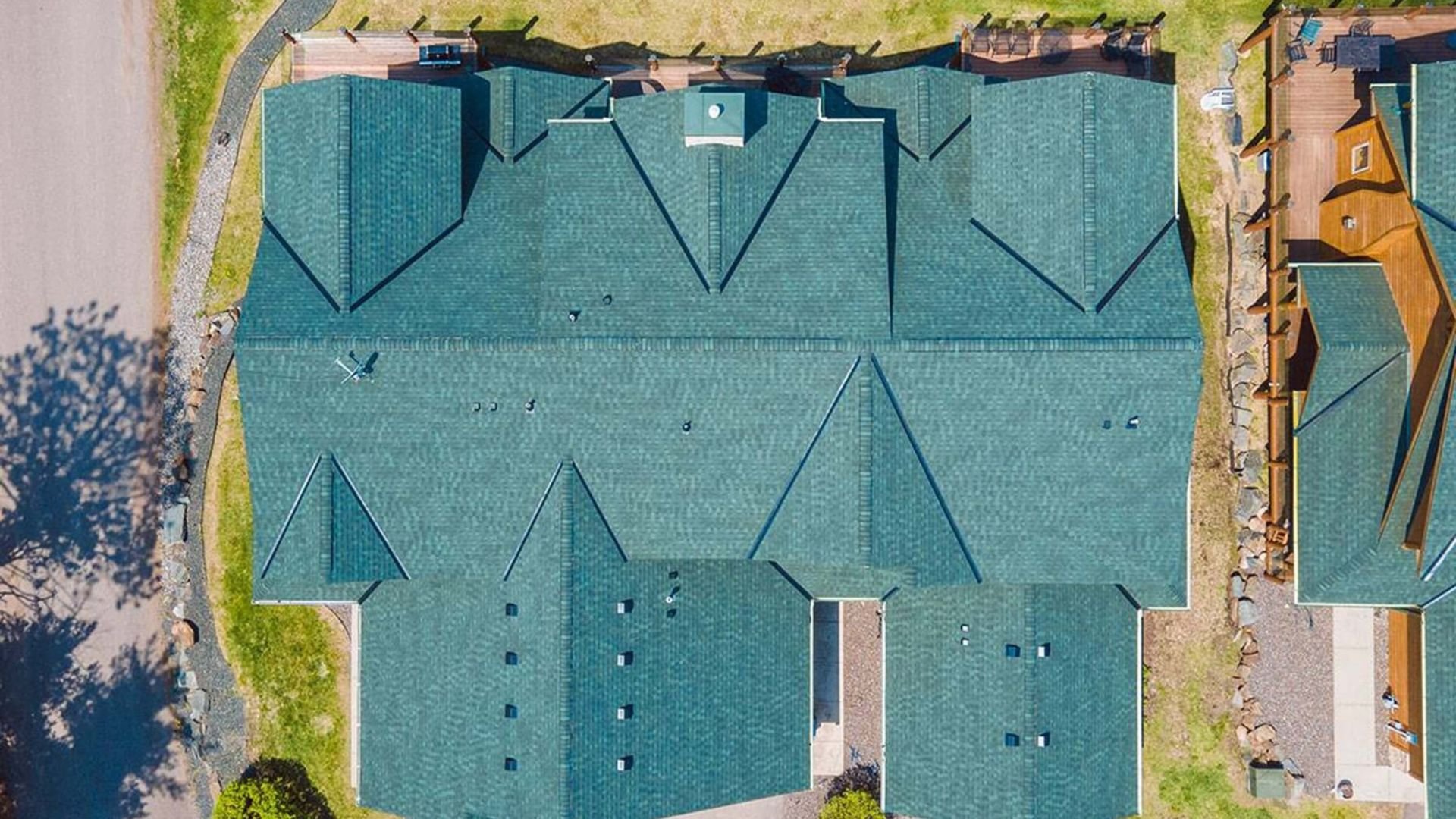 Aerial view of blue-green rooftops with complex geometric angles